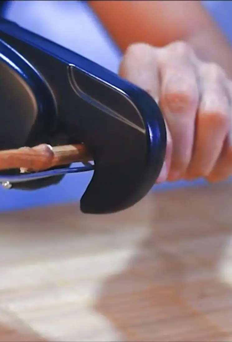 Electric vineyard tying machine tying a vine shoot